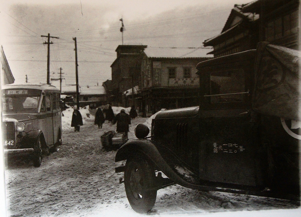 「佐渡万華鏡」42　昭和10年　両津の夷海岸通り、手前は港タクシー事務所、後方のハト屋煙草店
